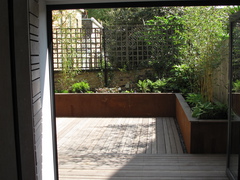 Cor-ten steel planters with a hardwood deck on two levels